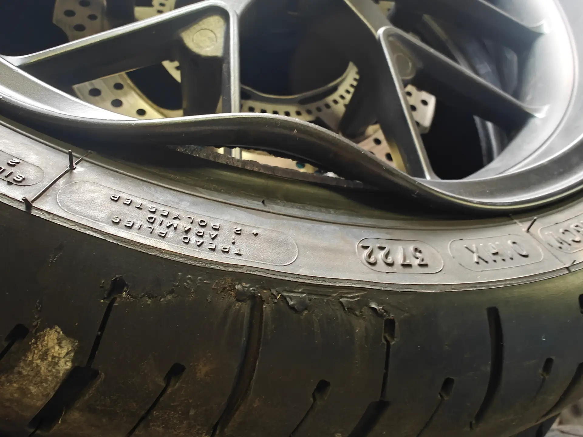 Cracked and bent motorcycle wheel before repair at ABBCO Car Service